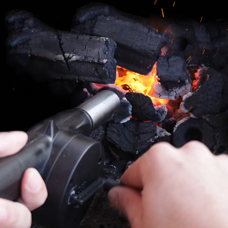 Ручной раздуватель раздувает угли